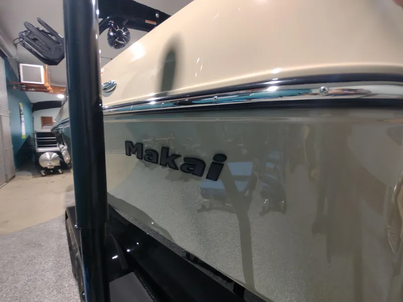 Slide: The Image of 2024 Moomba Makai boat in showroom, side view. - 13