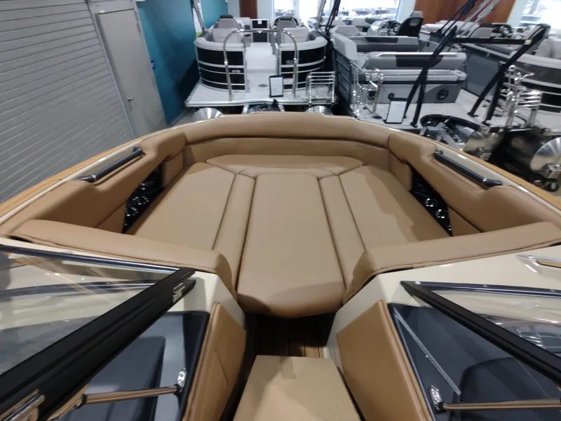 Slide: The Image of 2024 Moomba Makai boat interior with tan seating at a showroom. - 17