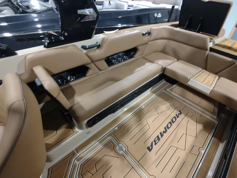 Slide: The Image of 2024 Moomba Makai boat interior with tan leather seating and custom flooring. - 18