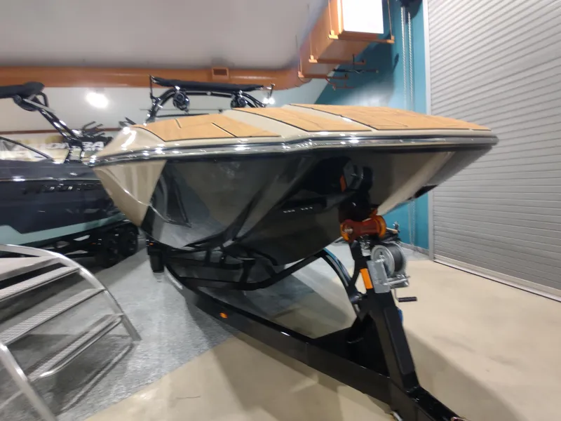 Slide: The Image of 2024 Moomba Makai boat on trailer in indoor showroom. - 3