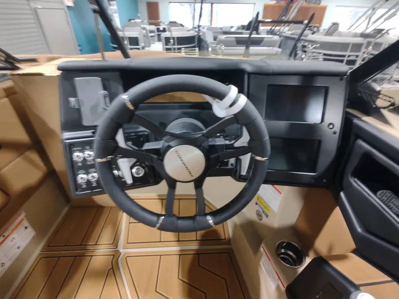 Slide: The Image of 2024 Moomba Makai boat dashboard with steering wheel and control panel. - 5