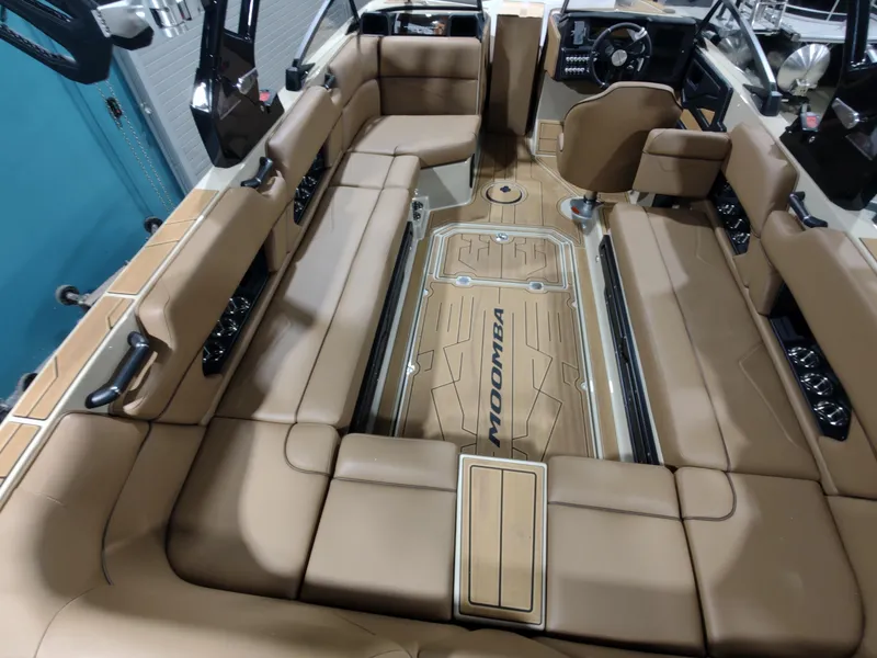 Slide: The Image of 2024 Moomba Makai boat interior with tan leather seating and modern dashboard. - 7