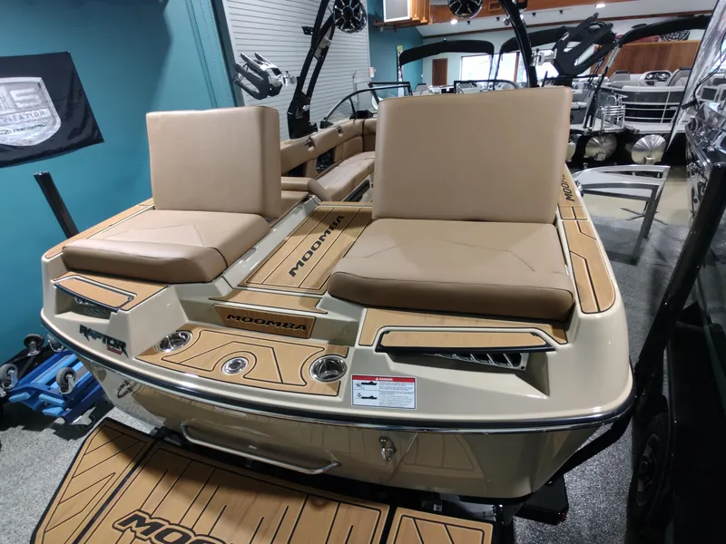 Slide: The Image of 2024 Moomba Makai boat interior with tan seats and wood accents. - 8