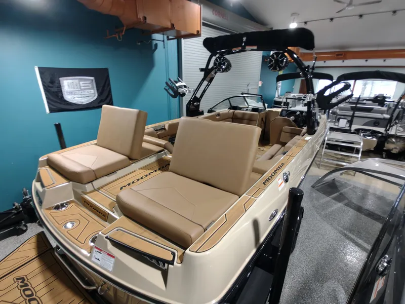 Slide: The Image of 2024 Moomba Makai boat interior with tan seating in showroom. - 9