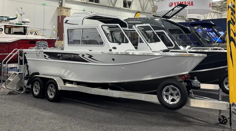 The Image of 2024 Weldcraft 200 Revolution F200 boat on display, featuring sleek design and dual-axle trailer. - 0