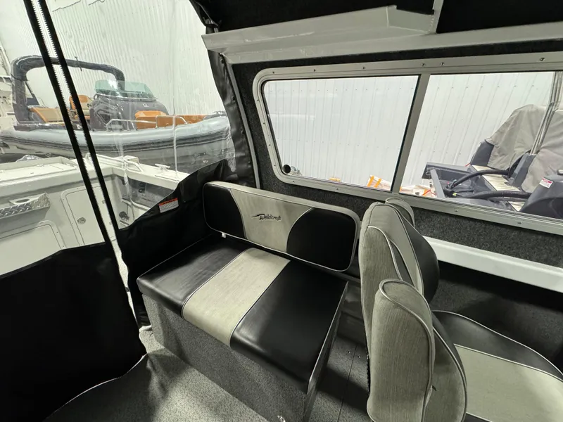 Slide: The Image of 2024 Weldcraft 200 Revolution F200 boat interior with seating and window view. - 17
