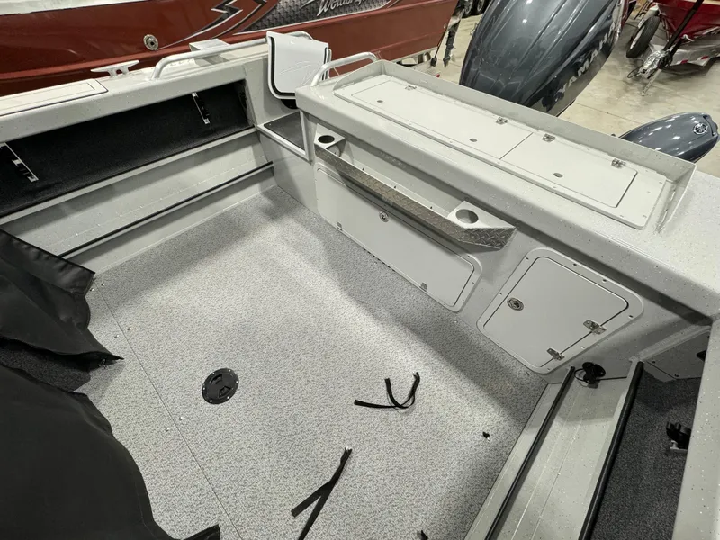 Slide: The Image of 2024 Weldcraft 200 Revolution F200 boat interior, spacious deck, storage compartments. - 18