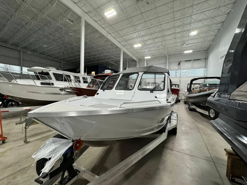 Slide: The Image of 2024 Weldcraft 200 Revolution F200 boat in stock, displayed in a showroom. - 6