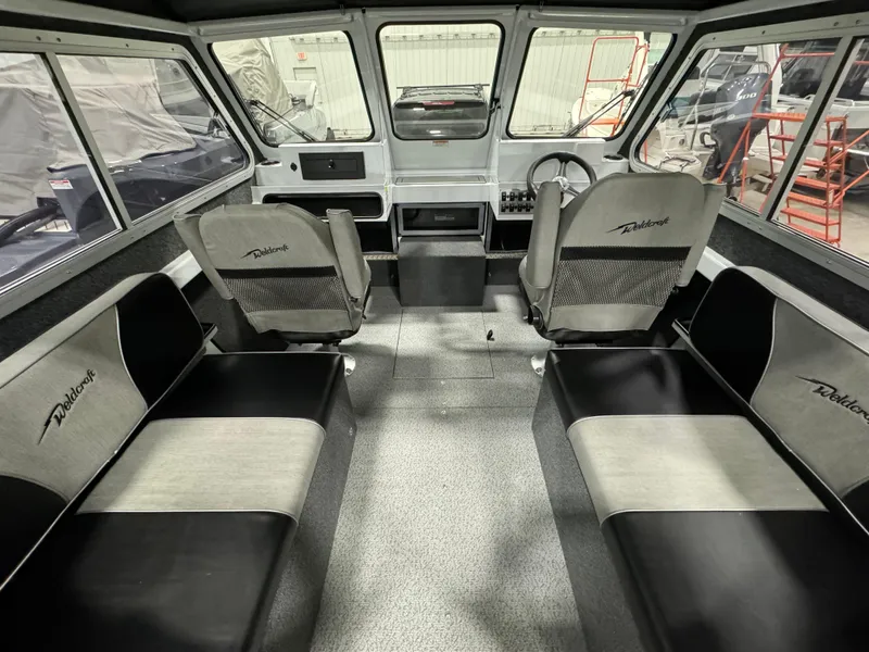 Slide: The Image of Interior of 2024 Weldcraft 200 Revolution F200 boat with seating and steering console. - 1