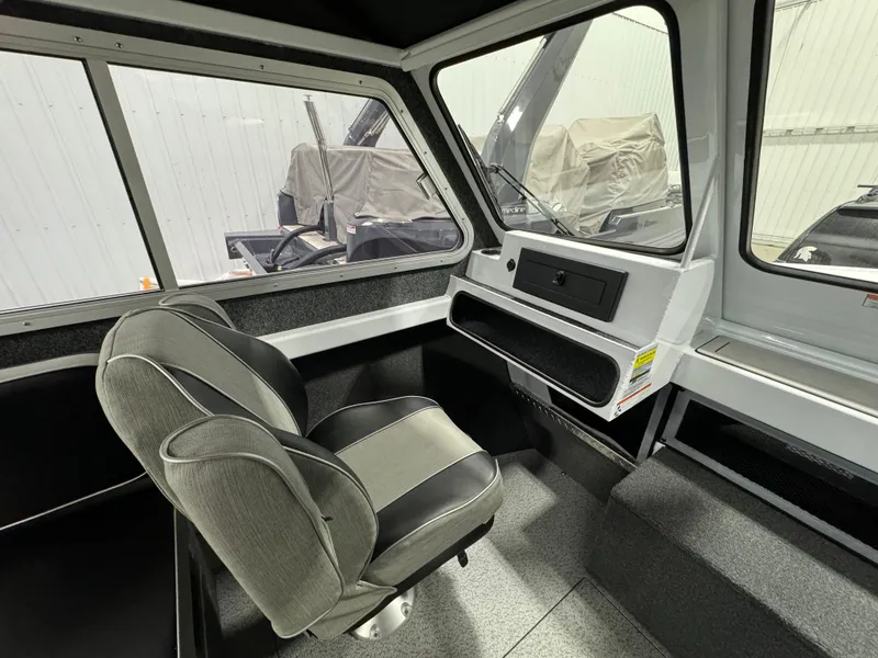 Slide: The Image of 2024 Weldcraft 200 Revolution F200 boat interior with seating and dashboard. - 13