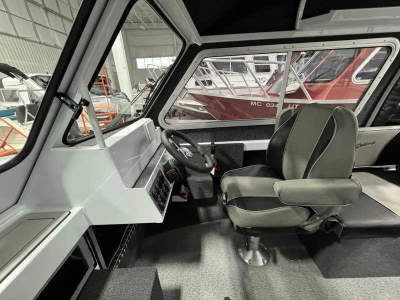 Slide: The Image of 2024 Weldcraft 200 Revolution F200 boat interior with captain's chair and steering wheel. - 14