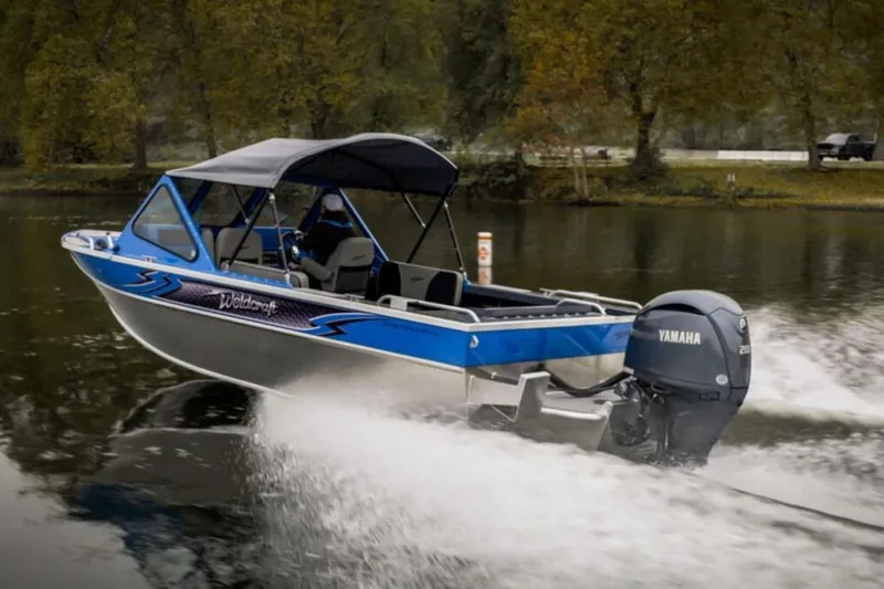 Slide: The Image of 2024 Weldcraft 200 Revolution F200 boat cruising on a lake with Yamaha outboard motor. - 20