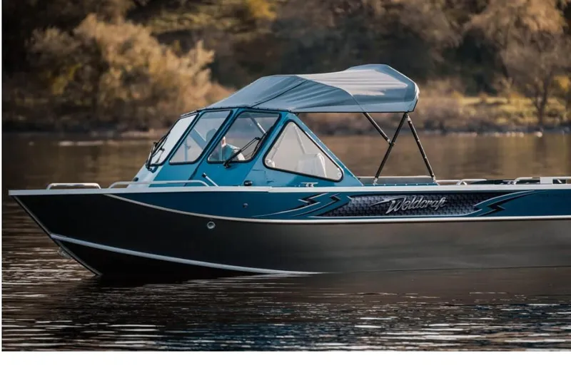 Slide: The Image of 2024 Weldcraft 200 Revolution F200 boat on calm water. - 23