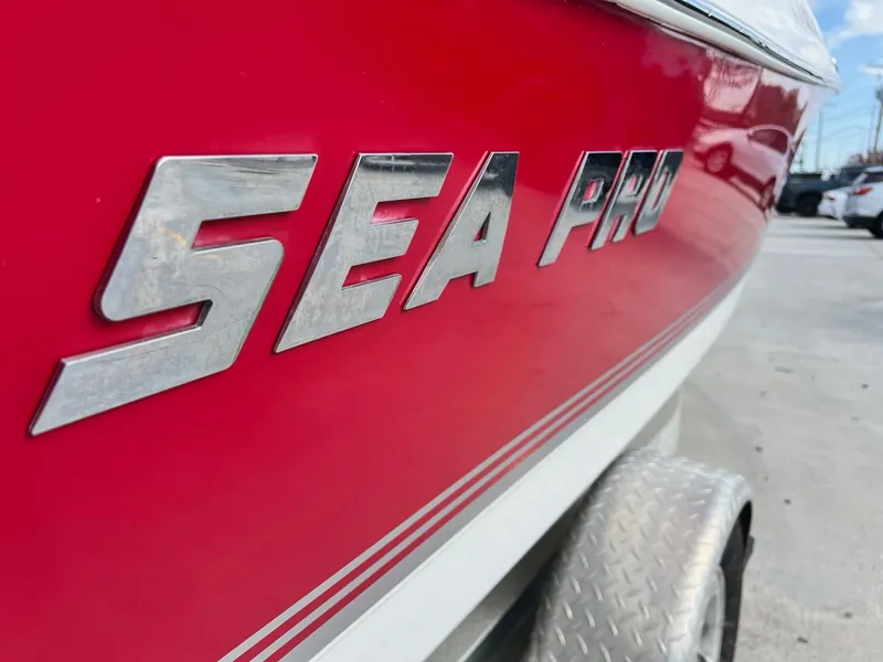 Slide: The Image of 2007 Sea Pro SP186D boat with red exterior on trailer. - 2