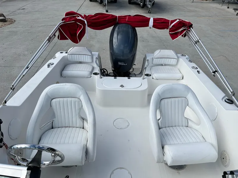 Slide: The Image of 2007 Sea Pro SP186D boat interior with white seating and red canopy. - 5