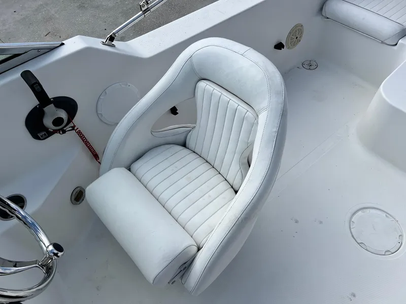 Slide: The Image of 2007 Sea Pro SP186D boat interior with white captain's chair and steering wheel. - 6