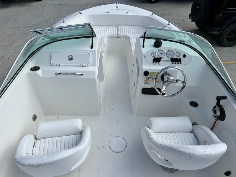Slide: The Image of 2007 Sea Pro SP186D boat interior with white seating and control panel. - 8