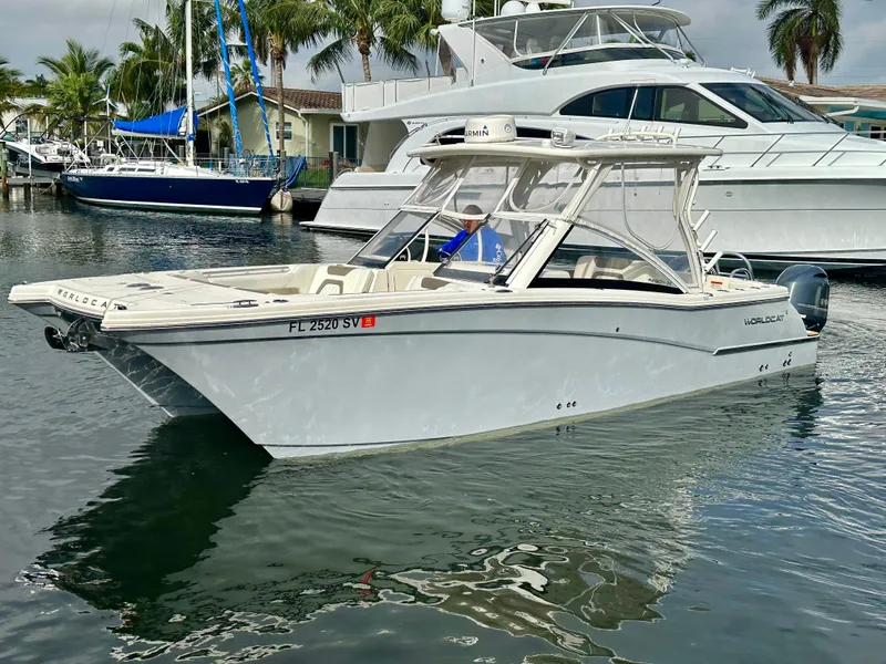 The Image of 2021 World Cat 280 DC-X boat docked in a marina with other vessels. - 0