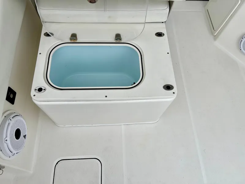 Slide: The Image of 2021 World Cat 280 DC-X boat deck with open storage compartment. - 13