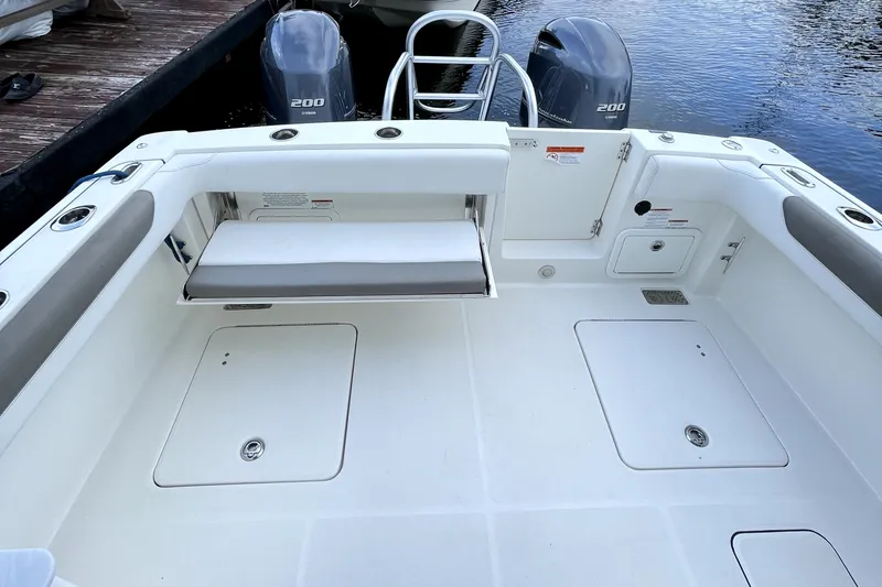 Slide: The Image of 2021 World Cat 280 DC-X boat deck with dual engines and seating area. - 14