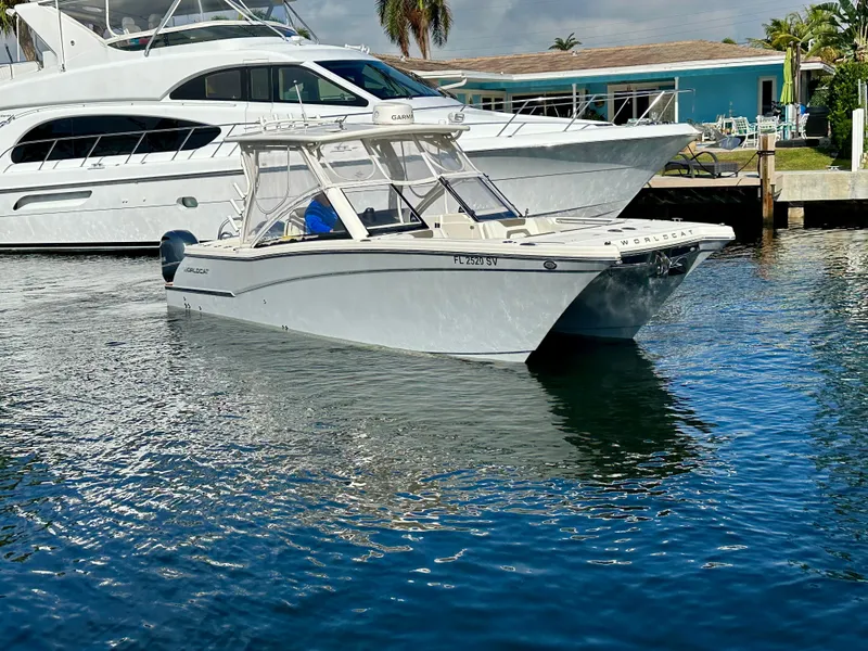 Slide: The Image of 2021 World Cat 280 DC-X boat docked in a marina, surrounded by water. - 5