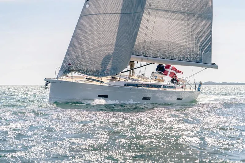 The Image of 2025 X-Yachts X-4.9 sailing on sparkling water with a Danish flag. - 0