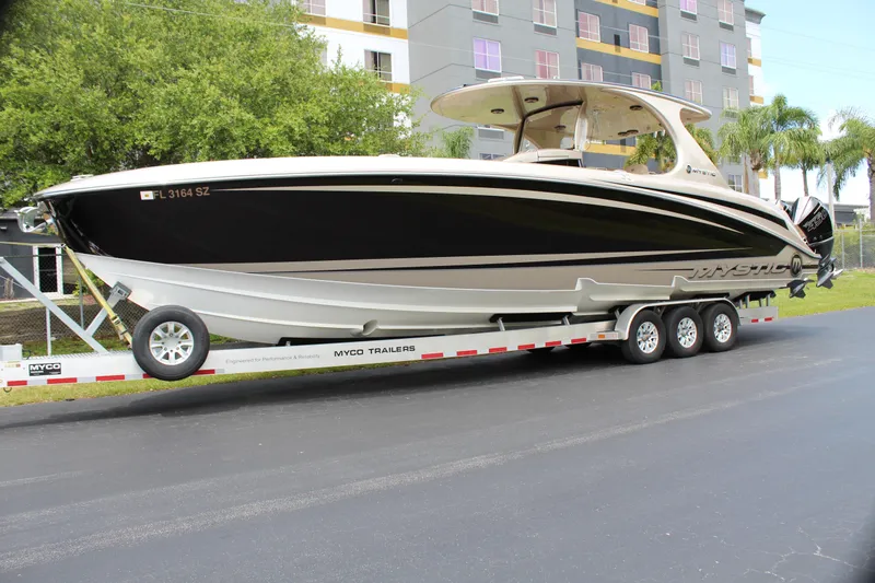 Slide: The Image of 2021 Mystic Powerboats M4200 on a trailer, parked on a street. - 0