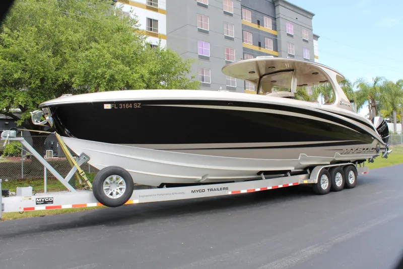 Slide: The Image of 2021 Mystic Powerboats M4200 on a trailer in front of a building. - 1
