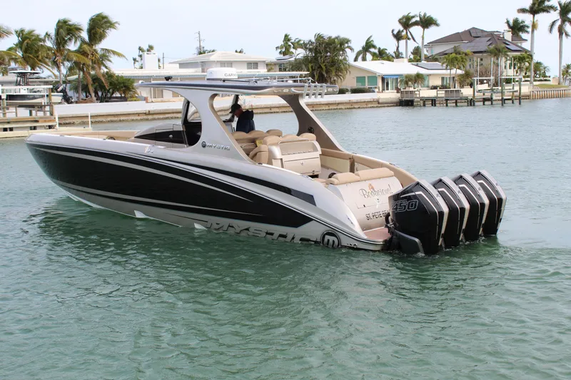 Slide: The Image of 2021 Mystic Powerboats M4200 on water with quad outboard engines. - 17