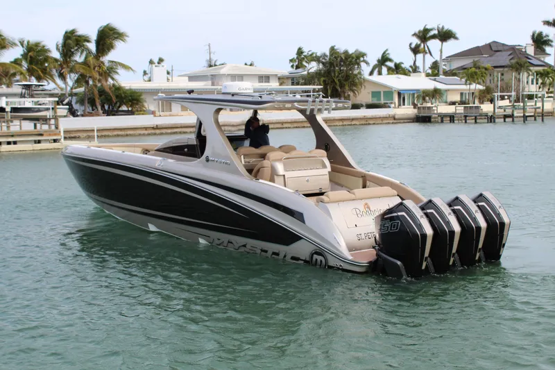 Slide: The Image of 2021 Mystic Powerboats M4200 on water with quad outboard engines. - 18