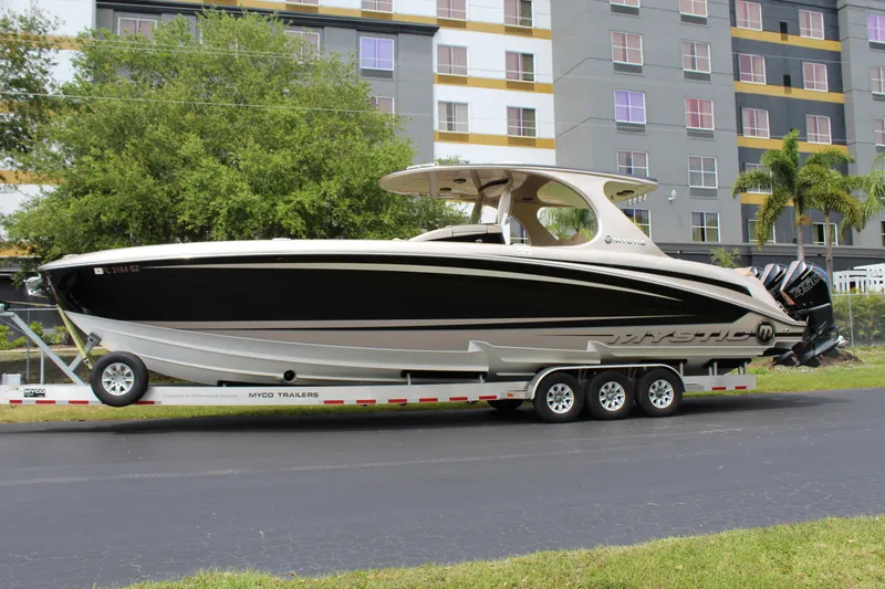 Slide: The Image of 2021 Mystic Powerboats M4200 on a trailer in front of a building. - 2