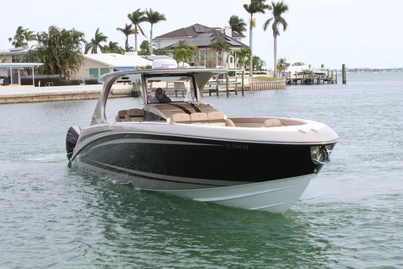 Slide: The Image of 2021 Mystic Powerboats M4200 cruising near waterfront homes. - 20