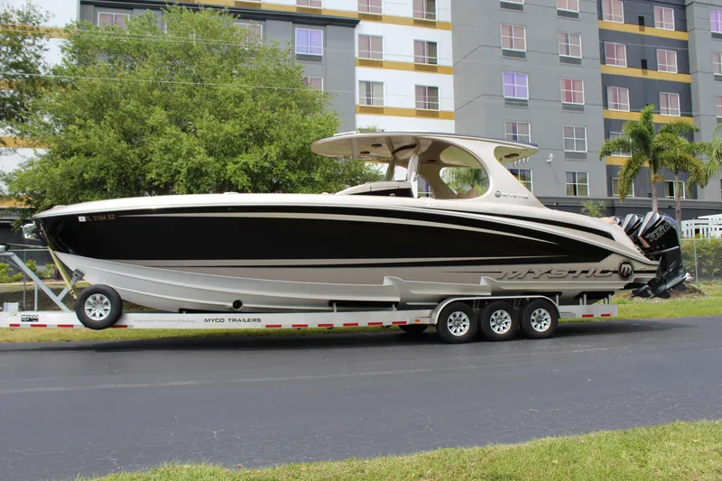 Slide: The Image of 2021 Mystic Powerboats M4200 on a trailer in front of a building. - 3