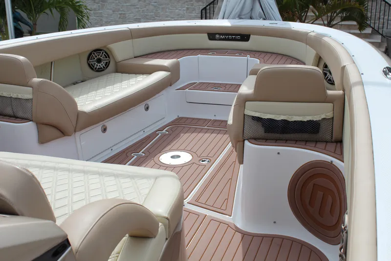 Slide: The Image of 2021 Mystic Powerboats M4200 interior with beige seating and teak flooring. - 38