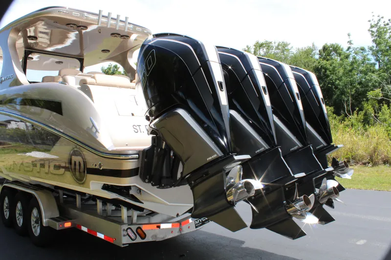 Slide: The Image of 2021 Mystic Powerboats M4200 with quad outboard engines on trailer. - 4
