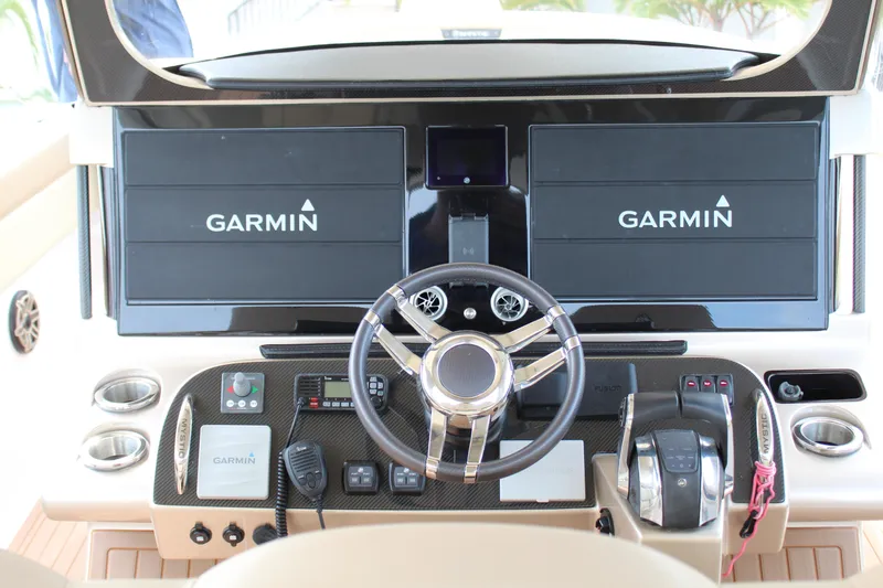 Slide: The Image of 2021 Mystic Powerboats M4200 helm with dual Garmin displays and advanced controls. - 46