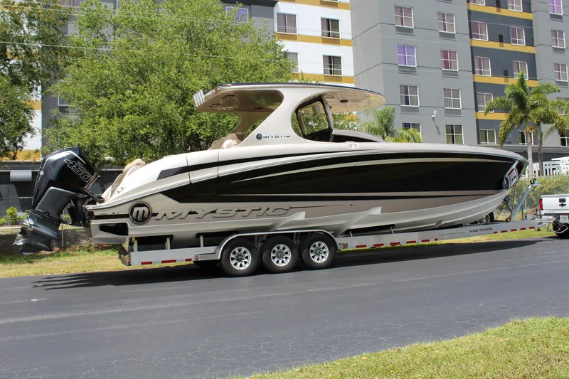 Slide: The Image of 2021 Mystic Powerboats M4200 on a trailer in an urban setting. - 8