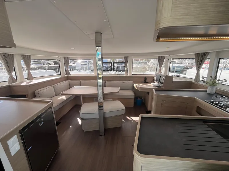 Slide: The Image of Spacious interior of 2025 Lagoon 42 catamaran with modern kitchen and seating area. - 39