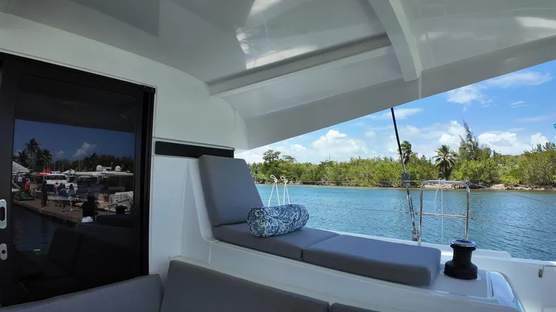Slide: The Image of 2025 Lagoon 42 yacht interior with scenic water view and comfortable seating. - 44