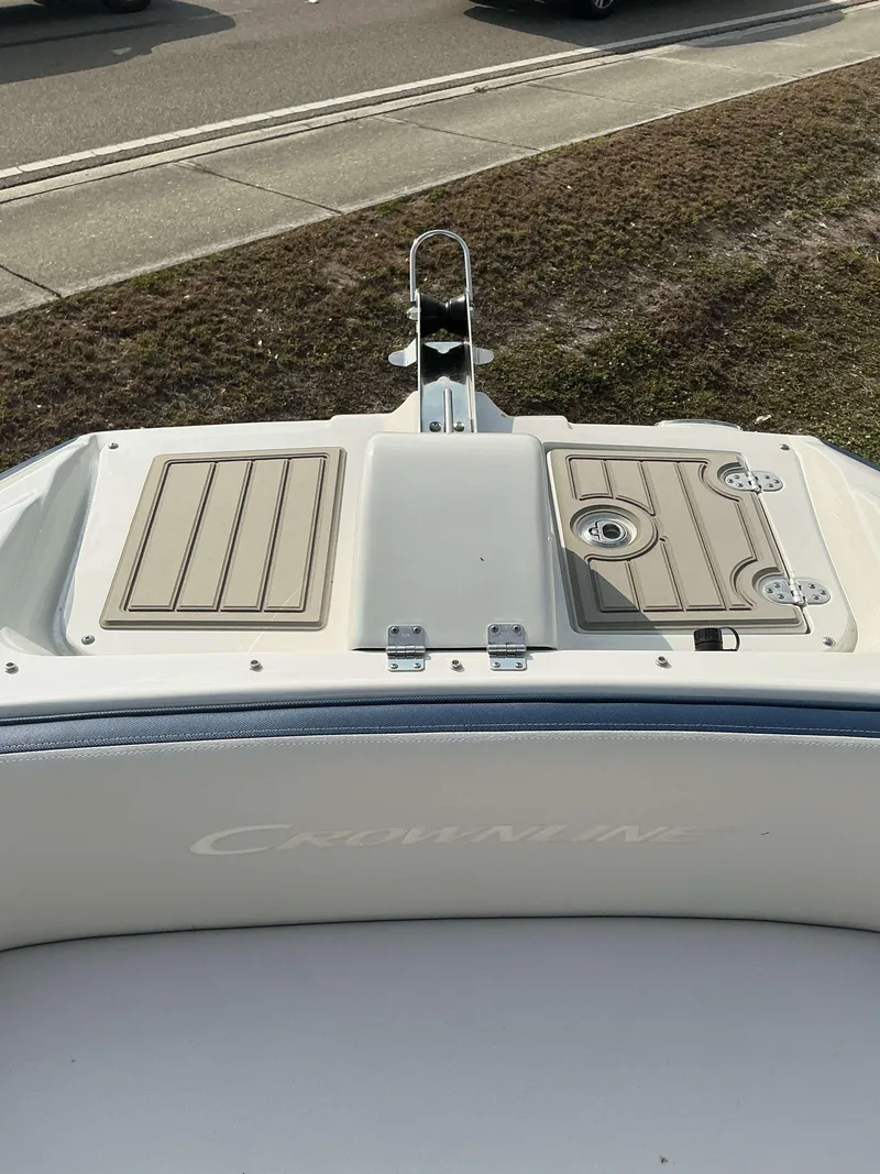 Slide: The Image of 2024 Crownline 290 XS boat deck with storage compartments and sleek design. - 10