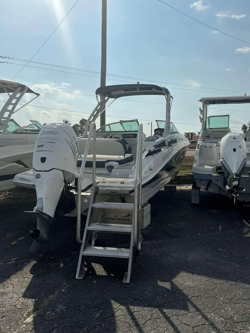 Slide: The Image of 2024 Crownline 290 XS boat with outboard motor, displayed outdoors. - 3