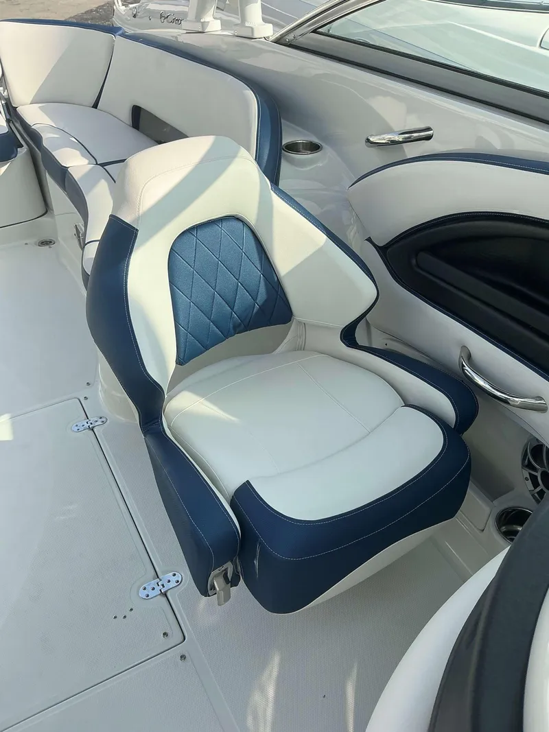 Slide: The Image of 2024 Crownline 290 XS boat interior with blue and white seating. - 9