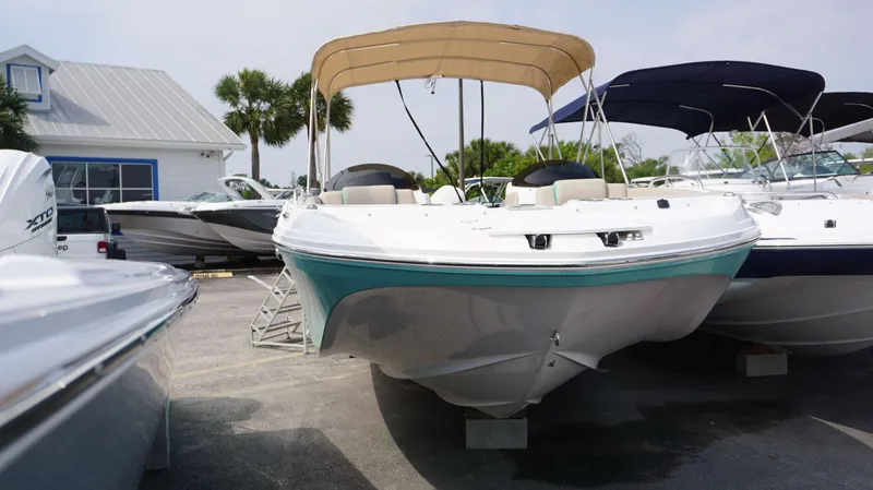 Slide: The Image of 2024 Hurricane 218 SS boat with canopy in a marina. - 1