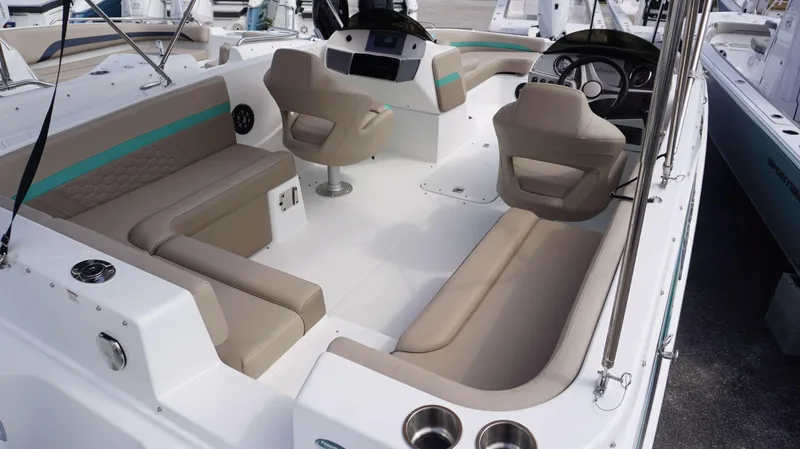 Slide: The Image of 2024 Hurricane 218 SS boat interior with beige seating and modern dashboard. - 13
