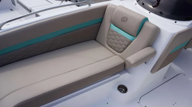 Slide: The Image of 2024 Hurricane 218 SS boat interior seating with teal accents and armrest. - 15