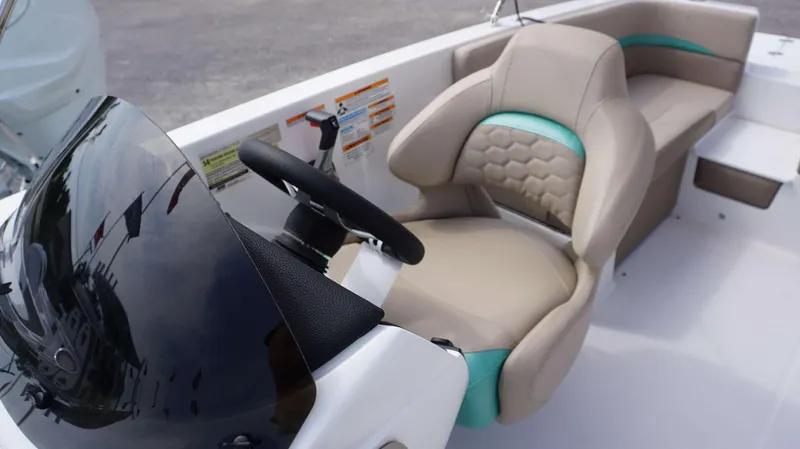 Slide: The Image of 2024 Hurricane 218 SS boat interior with steering wheel and comfortable seating. - 2
