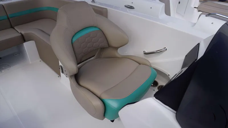 Slide: The Image of 2024 Hurricane 218 SS boat interior with beige and teal seating. - 3