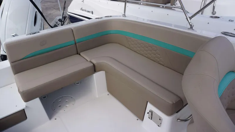 Slide: The Image of 2024 Hurricane 218 SS boat with beige and teal seating. - 4