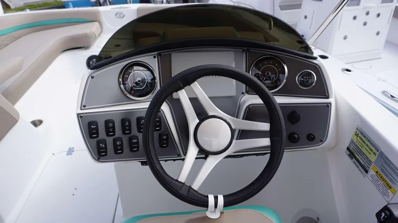 Slide: The Image of 2024 Hurricane 218 SS boat dashboard with steering wheel and control panel. - 7