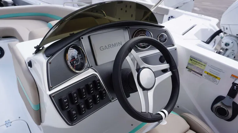 Slide: The Image of 2024 Hurricane 218 SS boat dashboard with Garmin navigation system and steering wheel. - 8